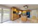 Bright kitchen featuring wood cabinets, granite countertops, center island, and access to outdoor screened space at 611 Stowe Rd, Clover, SC 29710