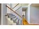 Elegant staircase with white railings and plush carpet treads leading to the upper level at 611 Stowe Rd, Clover, SC 29710