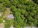 An aerial view of a house surrounded by mature trees, with street access at 627 S Chapel St, Landis, NC 28088