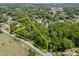 An aerial view of the property, outlining its boundaries and proximity to wooded areas at 627 S Chapel St, Landis, NC 28088