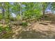 Picturesque backyard with a quaint bridge, small stream, and a relaxing bench area amidst lush greenery at 627 S Chapel St, Landis, NC 28088