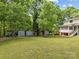 Expansive backyard featuring multiple outbuildings and a playset, perfect for outdoor fun and storage at 627 S Chapel St, Landis, NC 28088