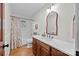 Bright bathroom with a wooden vanity, white countertop, and a shower-tub combo with curtain at 627 S Chapel St, Landis, NC 28088