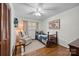 Cozy bedroom with hardwood floors, ceiling fan, and a comfortable chair with an accompanying side table at 627 S Chapel St, Landis, NC 28088