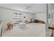 Spacious bonus room featuring dual ceiling fans, lots of natural light, and ample space for various activities at 627 S Chapel St, Landis, NC 28088
