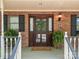 Inviting front entrance with a beautifully crafted wood door and manicured potted plants at 627 S Chapel St, Landis, NC 28088
