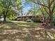 Inviting brick home with a covered porch and beautiful landscaping, set on a lush green lawn at 627 S Chapel St, Landis, NC 28088