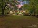 Charming two-story home with a well-manicured lawn, front porch, and mature trees at 627 S Chapel St, Landis, NC 28088