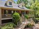 Charming two-story brick home featuring a covered front porch and well-maintained landscaping at 627 S Chapel St, Landis, NC 28088