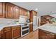 Kitchen with wooden cabinets, marble countertops, and modern appliances including double oven at 627 S Chapel St, Landis, NC 28088