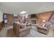 Basement Gathering room featuring exposed brick, fireplace, tv, and comfortable seating, for a relaxed atmosphere at 627 S Chapel St, Landis, NC 28088