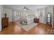Main bedroom featuring hardwood floors, ceiling fan, large windows, and a wrought iron bed frame at 627 S Chapel St, Landis, NC 28088