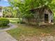 Charming rustic outbuilding adds character to the lush greenery surrounding the home at 627 S Chapel St, Landis, NC 28088