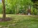 Fun backyard playground with slides and climbing structures provides entertainment for children at 627 S Chapel St, Landis, NC 28088