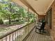 Charming covered porch features classic rocking chairs, offering a relaxing outdoor living space at 627 S Chapel St, Landis, NC 28088