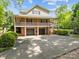 Spacious rear exterior showcasing a two-car garage and an expansive driveway at 627 S Chapel St, Landis, NC 28088