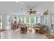 Sunroom with tile flooring, many windows and seating options, and a ceiling fan at 627 S Chapel St, Landis, NC 28088