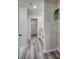 View of primary bathroom featuring a walk-in shower, closet, granite-topped vanity, shelving, and wood-look vinyl at 721 32Nd Ne St, Conover, NC 28613