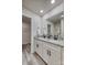 Primary bathroom featuring a granite countertop vanity with dual sinks, walk-in closet, and wood-look vinyl floors at 721 32Nd Ne St, Conover, NC 28613