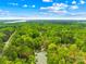 An aerial view of the property, showcasing its mature landscaping and lake access at 8451 Ridgewood Rd, Sherrills Ford, NC 28673