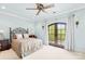 Relaxing bedroom with a ceiling fan, french doors, and bright-colored walls at 8451 Ridgewood Rd, Sherrills Ford, NC 28673