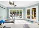 Bright exercise room boasts high ceilings, natural light, and outdoor access to a pool and patio at 8451 Ridgewood Rd, Sherrills Ford, NC 28673