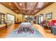 Spacious billiards room flows into basement bar area, featuring a coffered ceiling, and bright lighting at 8451 Ridgewood Rd, Sherrills Ford, NC 28673