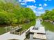 Picturesque lake view featuring multiple docks, lush trees, and calm waters on a sunny day at 8451 Ridgewood Rd, Sherrills Ford, NC 28673