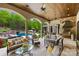 The covered patio offers ample seating, a built-in grill, and stunning views of the outdoor pool area at 8451 Ridgewood Rd, Sherrills Ford, NC 28673