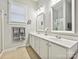 Bright bathroom with a large double sink vanity, framed mirrors, and a shower with glass doors at 9640 Alma Blount Blvd, Charlotte, NC 28277