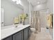 Bathroom features a vanity with sink and toilet, with a bath/shower combo and neutral-colored curtain at 9640 Alma Blount Blvd, Charlotte, NC 28277