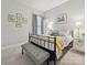 Cozy bedroom features a black metal bed frame, neutral bedding, accent pillows, and bedside table at 9640 Alma Blount Blvd, Charlotte, NC 28277