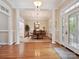 Elegant dining room featuring hardwood floors, wainscoting, and a chandelier at 9640 Alma Blount Blvd, Charlotte, NC 28277
