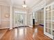 Spacious foyer with hardwood floors, elegant lighting, and beautiful french doors at 9640 Alma Blount Blvd, Charlotte, NC 28277