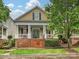 Charming home featuring a welcoming front porch with classic columns and a well-maintained front yard at 9640 Alma Blount Blvd, Charlotte, NC 28277