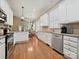 Spacious kitchen featuring white cabinets, stainless steel appliances, and hardwood floors at 9640 Alma Blount Blvd, Charlotte, NC 28277