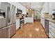 Modern kitchen with stainless steel appliances, white cabinetry, and hardwood floors at 9640 Alma Blount Blvd, Charlotte, NC 28277