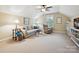 Cozy living room features a ceiling fan, neutral sofa, recliner chair, and natural light from a window at 9640 Alma Blount Blvd, Charlotte, NC 28277