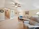 Comfortable living room features a vaulted ceiling, neutral sofa, recliner chair, and overhead fan at 9640 Alma Blount Blvd, Charlotte, NC 28277