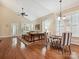 Bright living room showcasing hardwood floors, vaulted ceilings, and large windows with plantation shutters at 9640 Alma Blount Blvd, Charlotte, NC 28277