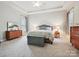 Calm main bedroom featuring tray ceilings, soft carpet, and plenty of natural light at 9640 Alma Blount Blvd, Charlotte, NC 28277