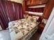 Cozy bedroom featuring wood cabinets, updated bedding and accents at 102 Eagle Ln, New London, NC 28127