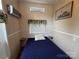 Comfortable bedroom with a window, built in shelves and neutral colors at 102 Eagle Ln, New London, NC 28127