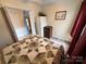 Bedroom featuring cozy carpet, floral bedding and a view into the closet at 102 Eagle Ln, New London, NC 28127