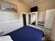 Bedroom featuring a large bed, mirrored closet doors and wall decor at 102 Eagle Ln, New London, NC 28127