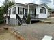 Attractive home with white siding, black shutters, and well-maintained gravel driveway at 102 Eagle Ln, New London, NC 28127