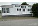 Charming white home featuring black shutters and patterned base at 102 Eagle Ln, New London, NC 28127