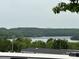 Scenic lake view with lush green trees and distant bridge at 102 Eagle Ln, New London, NC 28127