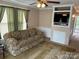 Comfortable living room with plush seating, TV, and bright interior at 102 Eagle Ln, New London, NC 28127