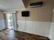 Living room with neutral colors, white trim, sliding glass door, and updated flooring at 102 Eagle Ln, New London, NC 28127